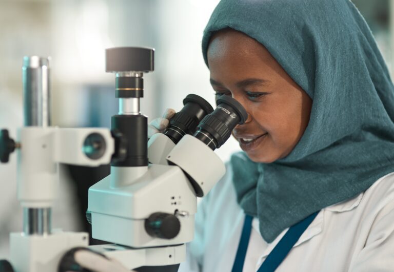 Girl Looking Through Microscope